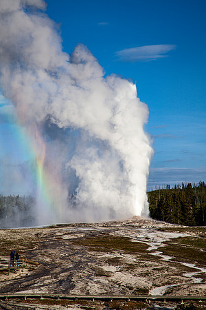 Rainbow during Old Faithful eruption shot from behind Old Faithful - 2012